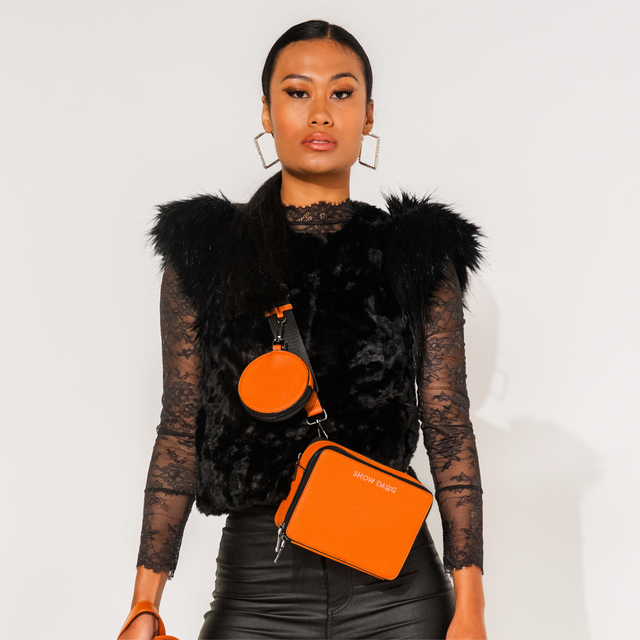 Fashion model wearing front side buffalo caramel vegan leather dog walking bag with detachable doggie treat pouch