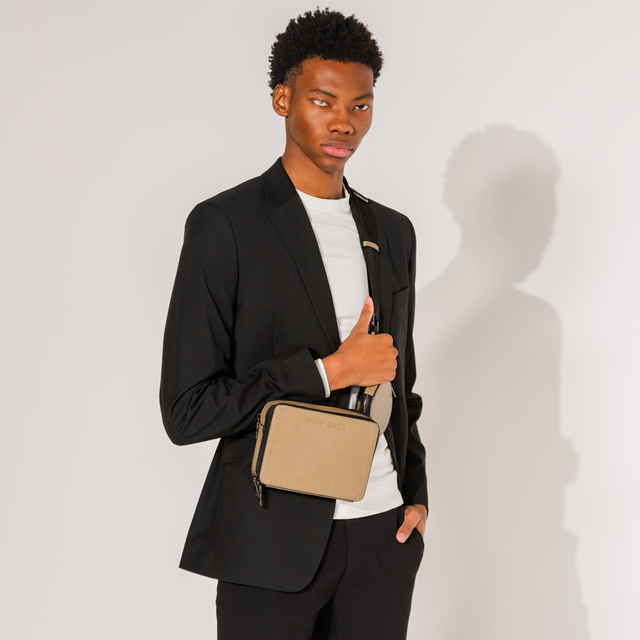 Fashion model wearing front side sandstone vegan leather dog walking bag with detachable doggie treat pouch 